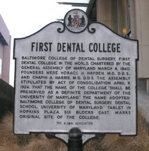 Landmark sign noting the Baltimore College of Dental Surgery as the world's first dental college.